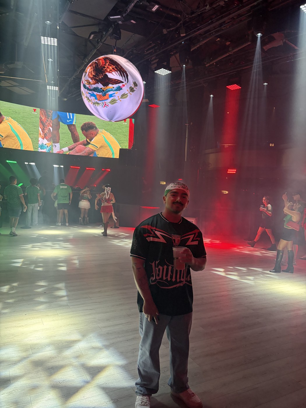 Dominic Alvarez at an event under red stage lighting