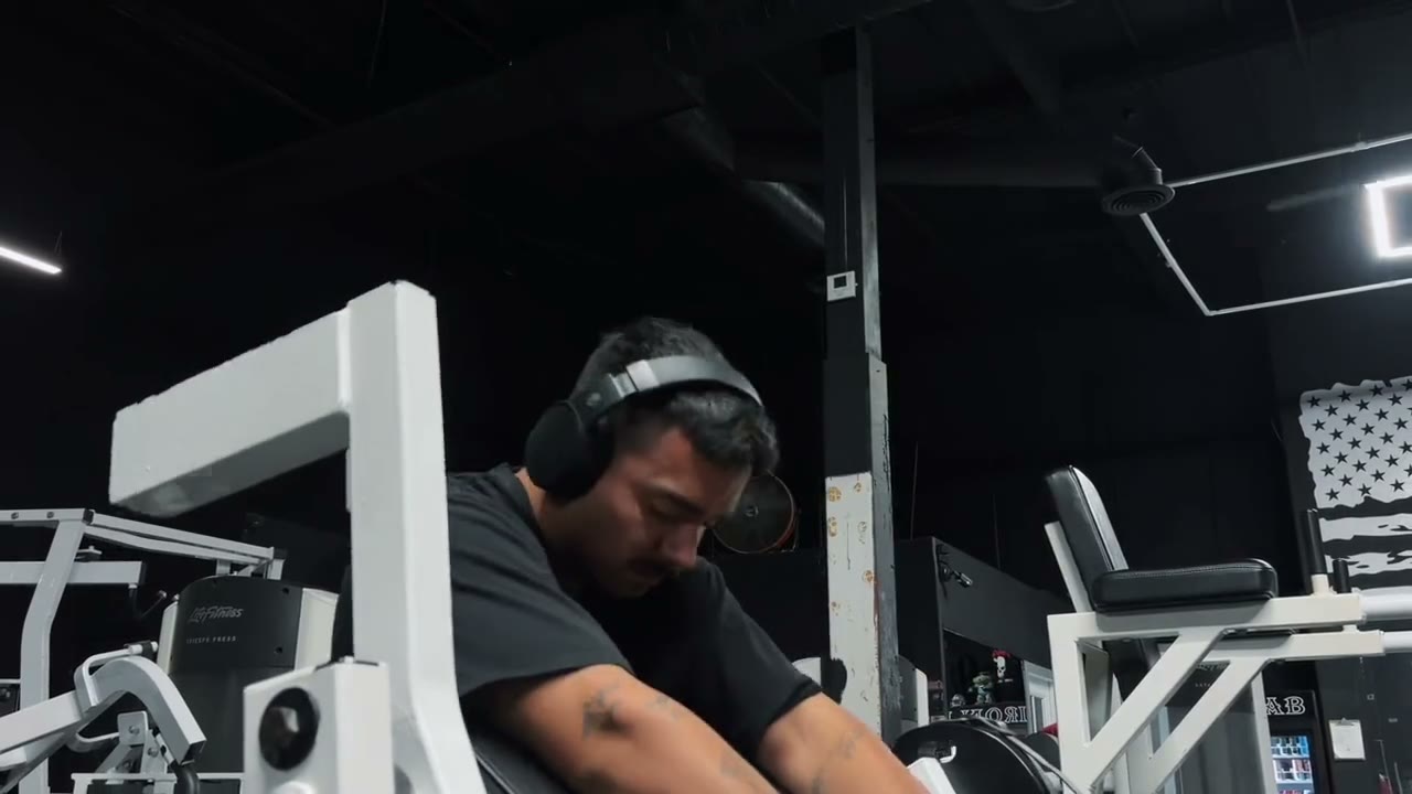 Dominic Alvarez seated at a machine in low light
