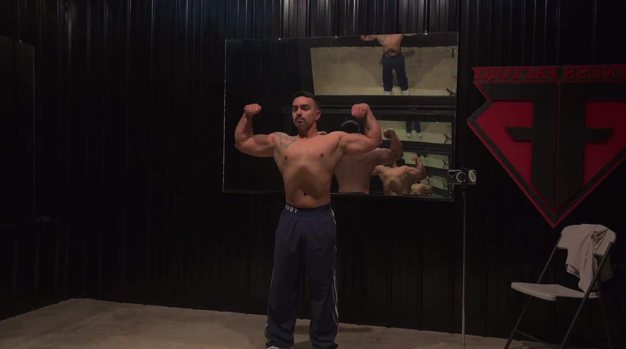Dominic Alvarez hitting a front double biceps pose