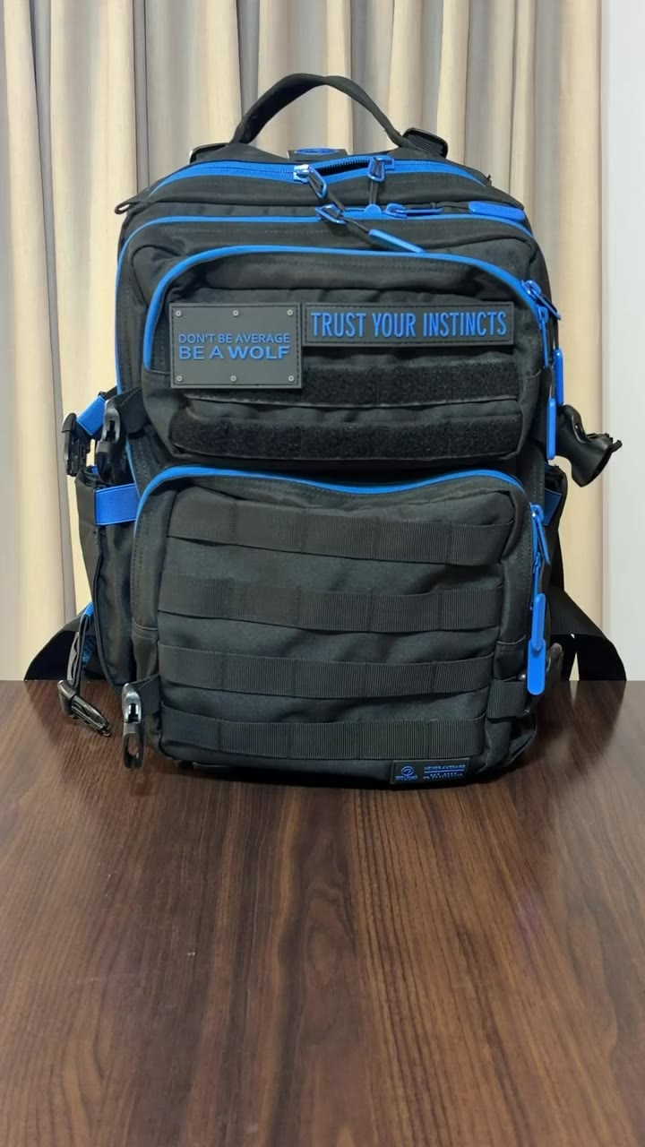 A black and blue tactical gym backpack on a table