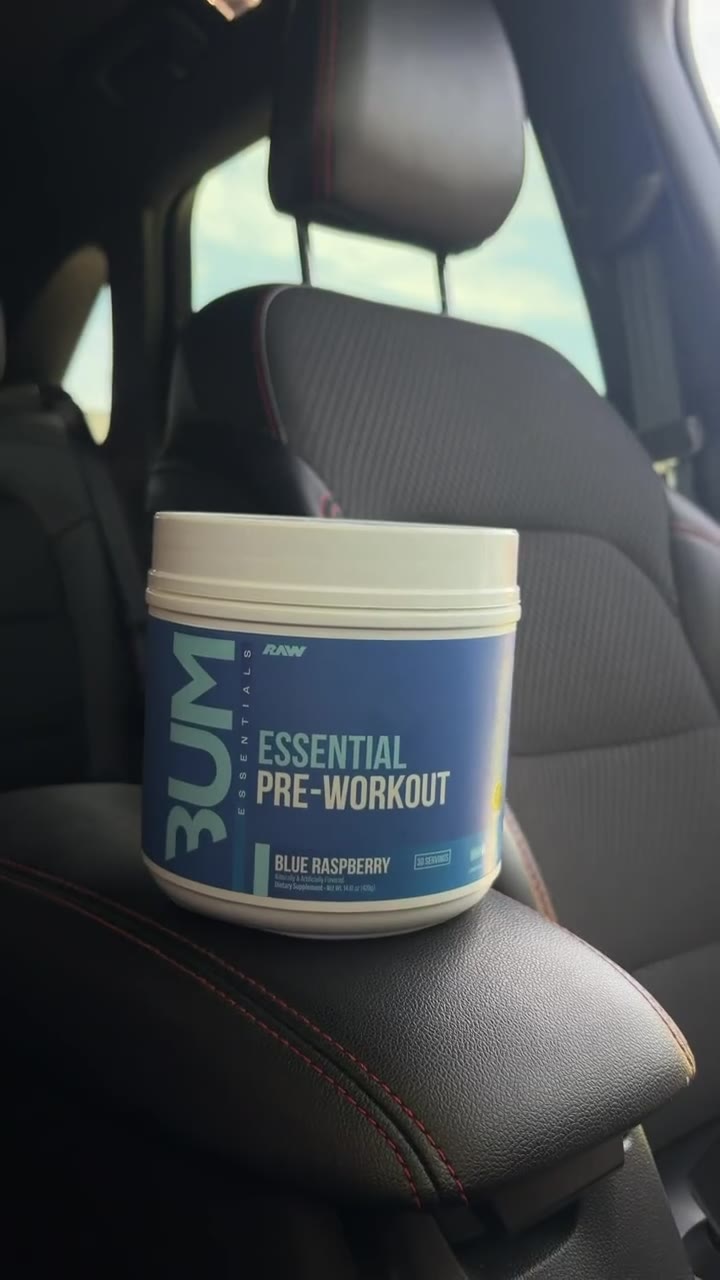 A tub of blue raspberry pre-workout on a car seat